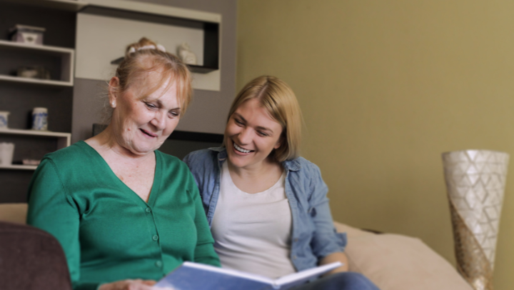 an old woman and her daughter smiling